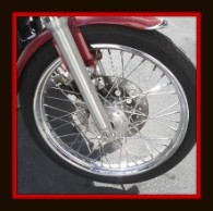 Motorcycle with front wheel lifted for detailing by Fifty Dollar Detail.